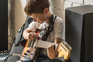 Boy playing guitar.